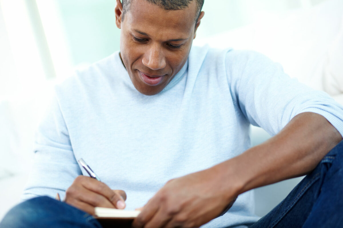 Man writing in journal