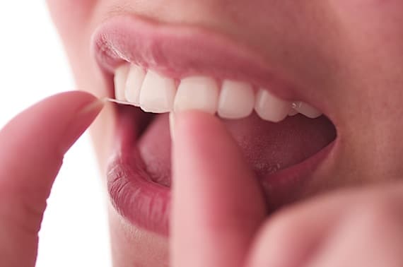 Close Up of Someone Flossing Their Teeth - Photo courtesy of ©iStockphoto.com/apletfx, Image #563258