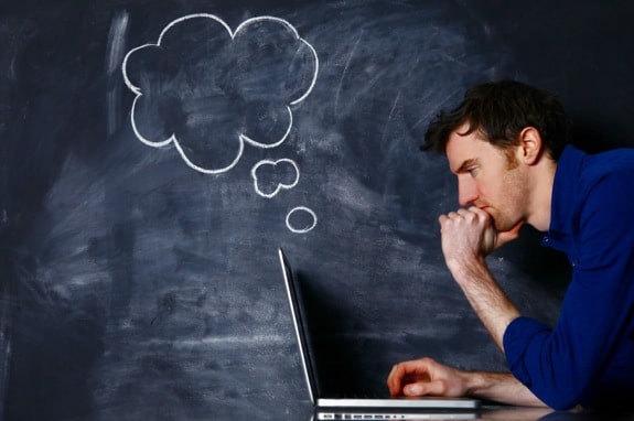 Man with a Laptop Against a Blackboard - Photo courtesy of ©iStockphoto.com/mattjeacock, Image #19460301