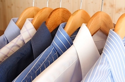 a clothes rack full of shirts neatly in a row